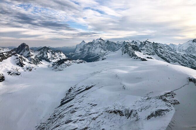 Matterhorn helicopter tour - longest scenic flight from Bern over the Swiss Alps - Glaciers and alpine chain views: mountain huts and the Bluemlisalhuette moment